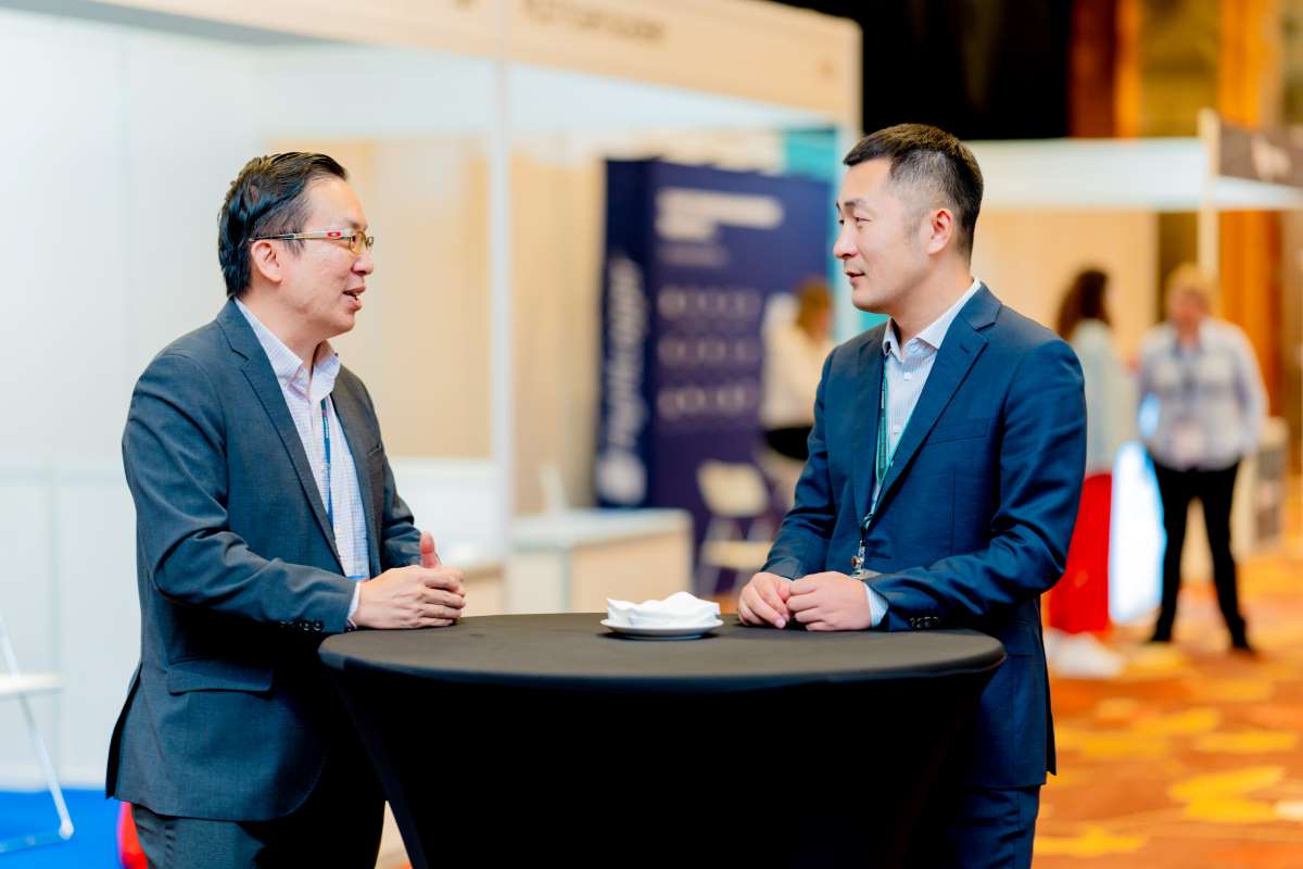 Two people in business attire engage in conversation